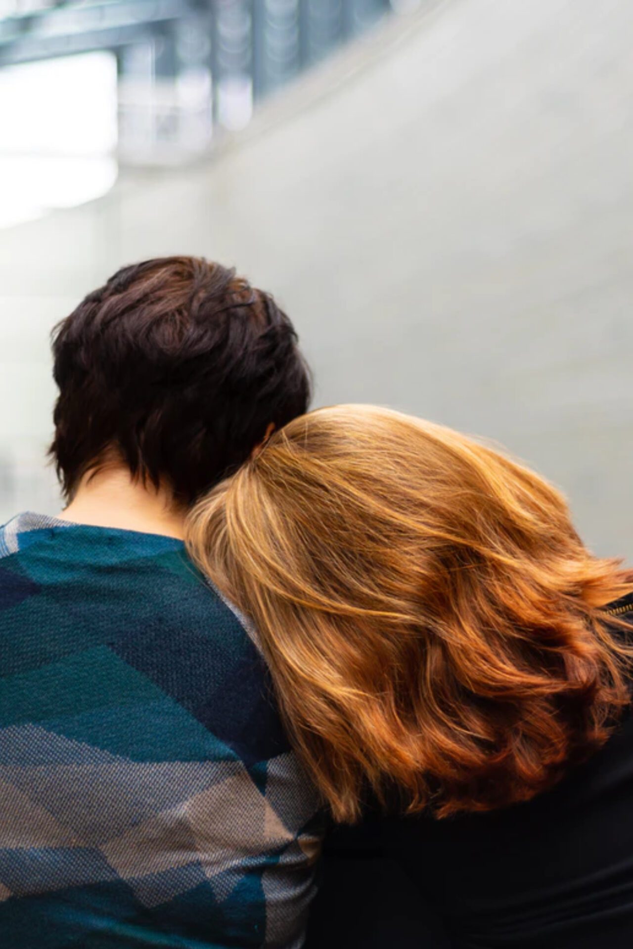 Photo of a man and woman talking at a table.